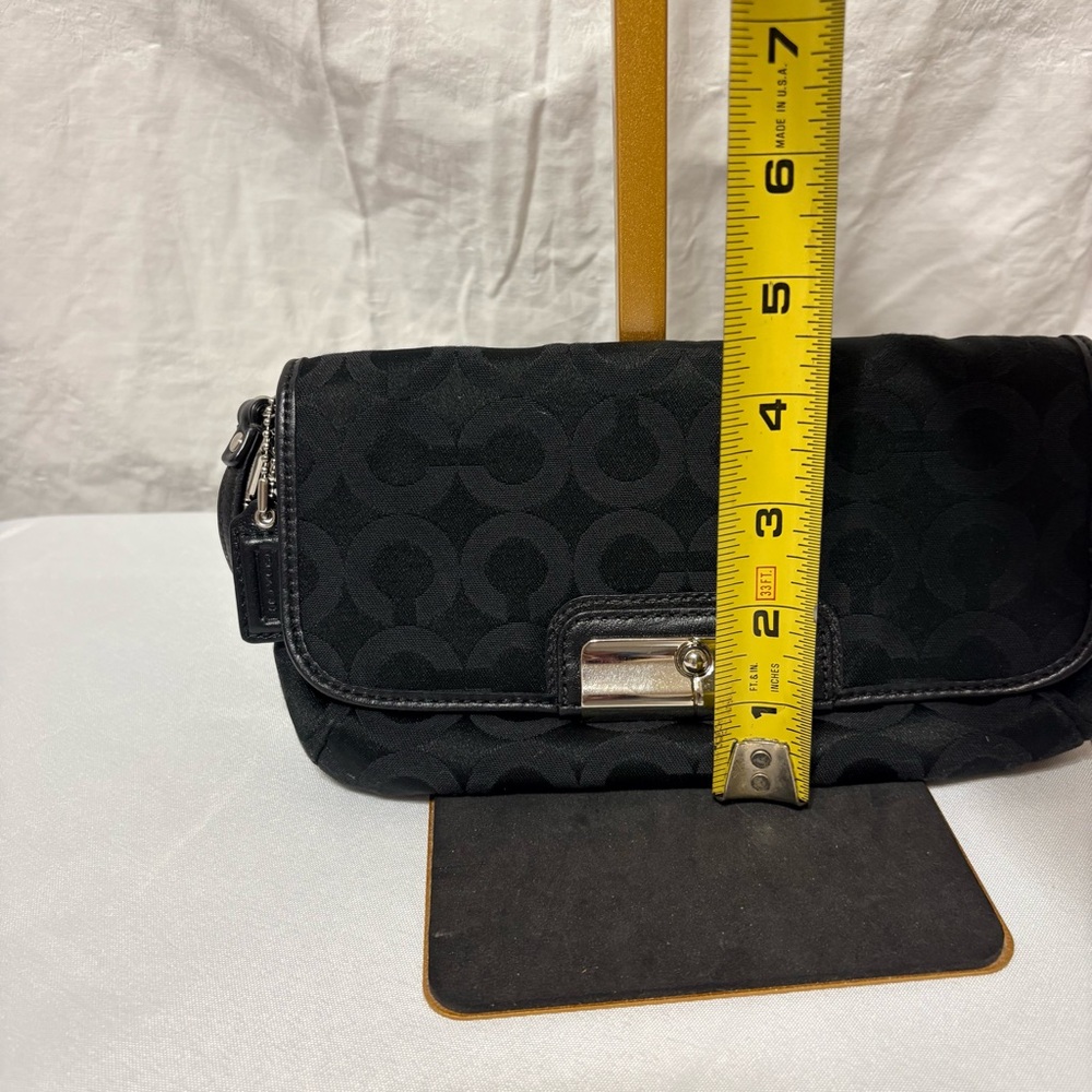 Black clutch wristlet, likely featuring silver-tone hardware - Picture 6 of 7